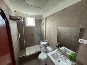 Baño con mampara de ducha y ventana