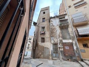 Calle estrecha con la casa y balcones