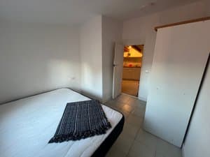 Dormitorio con cama doble y puerta al salón