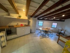 Salón comedor con vigas de madera y ventanas
