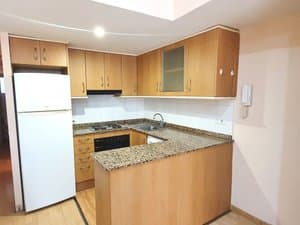 Cocina con frigorífico, placa y barra