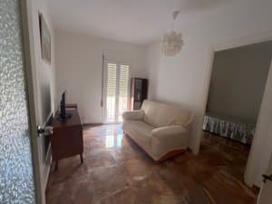 Salón con sofá y puerta a un dormitorio