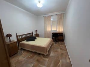 Dormitorio con cama de matrimonio y mesitas