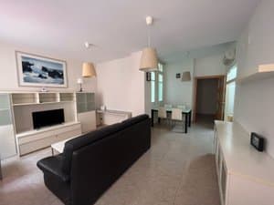 Salón con sofá y comedor al fondo