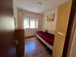 Dormitorio con cómoda y ventana