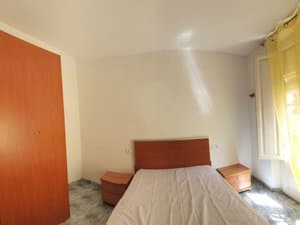 Dormitorio con armario y ventana