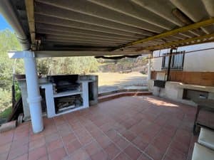 Porche con barbacoa y suelo de baldosa