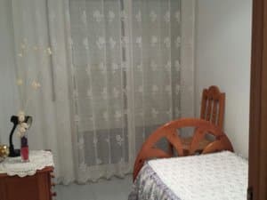 Dormitorio con cama individual y mesita
