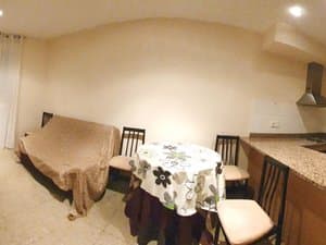 Comedor con mesa, sillas y barra de cocina
