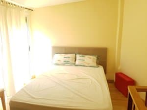 Dormitorio con cama de matrimonio y cortinas