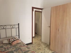 Dormitorio con cama de forja y armario