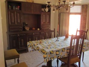 Comedor con mesa, aparador de madera y lámpara de araña