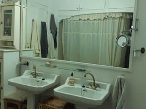 Baño con doble lavabo y espejo
