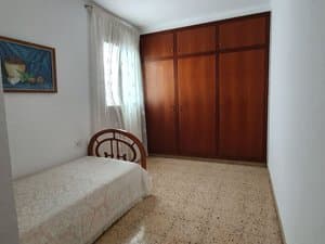 Dormitorio con cama individual y armario empotrado