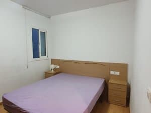 Dormitorio con cama de matrimonio y mesitas