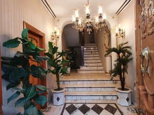 Vestíbulo de entrada con escalera al fondo