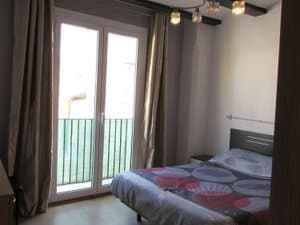 Dormitorio con cama de matrimonio y salida al balcón