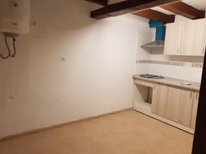 Cocina con muebles nuevos, placa de gas y vigas