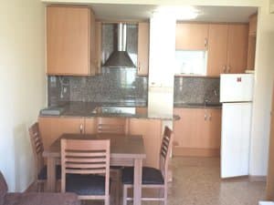 Cocina comedor con mesa, campana y frigorífico