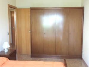 Dormitorio con armario empotrado de madera