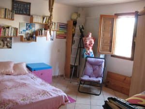 Dormitorio con estanterías y ventana
