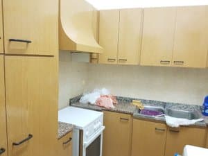 Cocina con muebles de madera, campana y fregadero doble