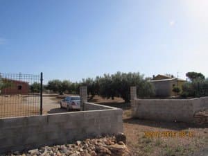 Entrada a la finca con muro y valla